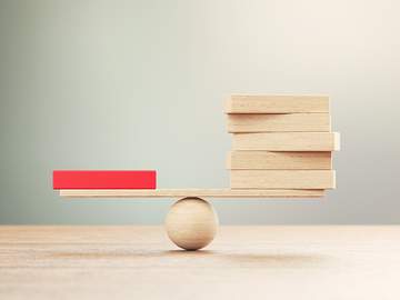 balance beam with one block on one side and several on the other